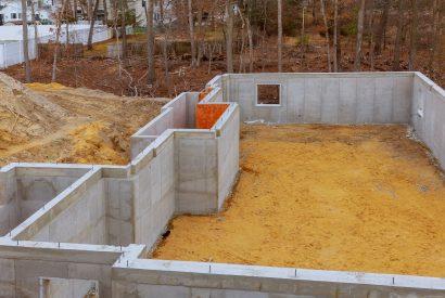 Under construction foundation new home with cement basement foundation